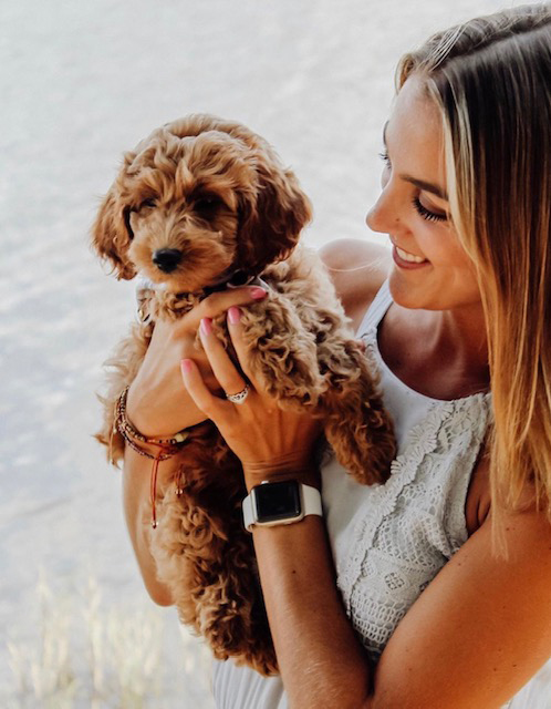 happy customers smiling girl holding puppy